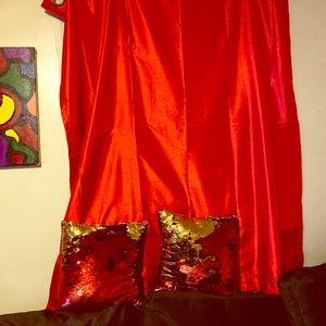 Two red curtains two red /gold decorative pillows